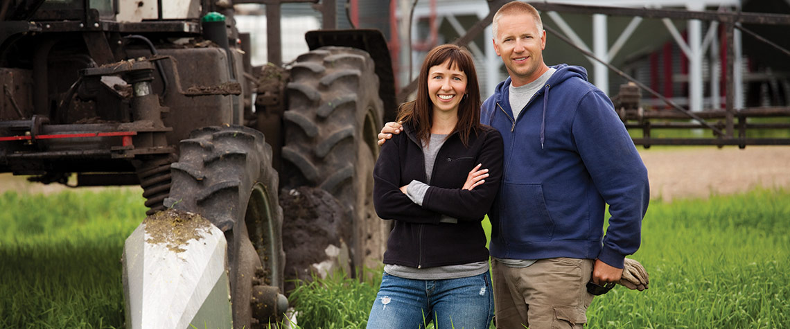 Two Ephrata National Bank agricultural banking customers standing in front of their tractor
